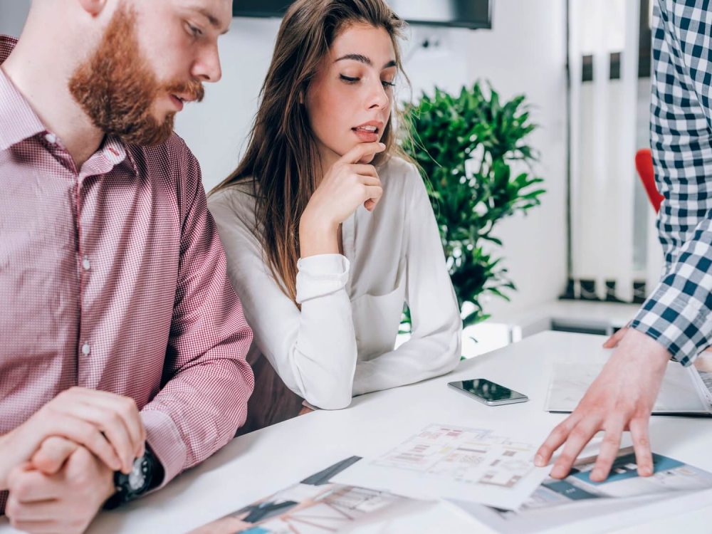 couple-in-real-estate-agency-talking-to-real-estate-agent-1.jpg